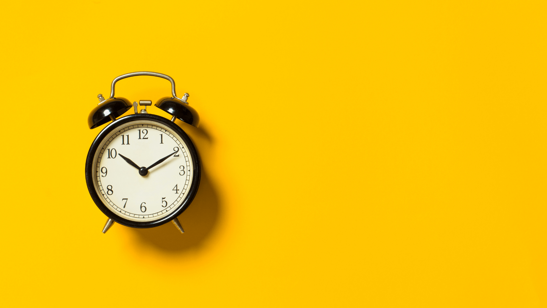 alarm clock on yellow background